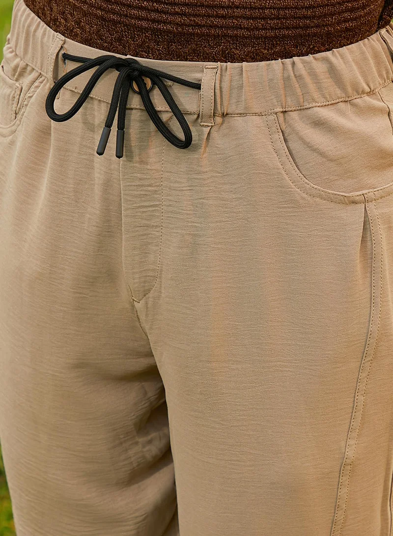 CAHOOT  Men's Khaki Beige Solid Tapered Trousers For Casual Wear | Low-Rise | 4 Pockets | Drawstring Closure | Trousers Crafted With Comfort Fit For Everyday Wear for Men | Best Price UAE